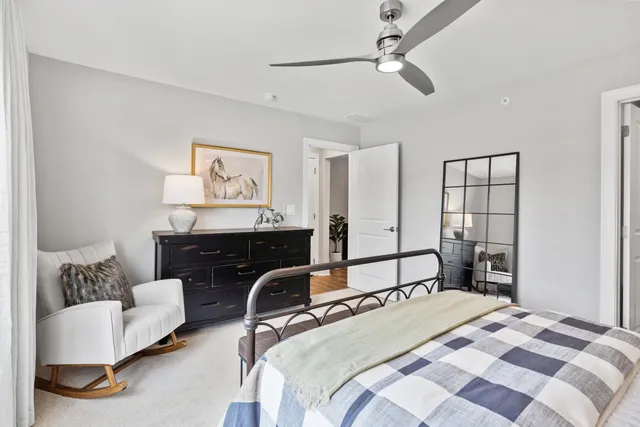 a bedroom with a bed couch and window