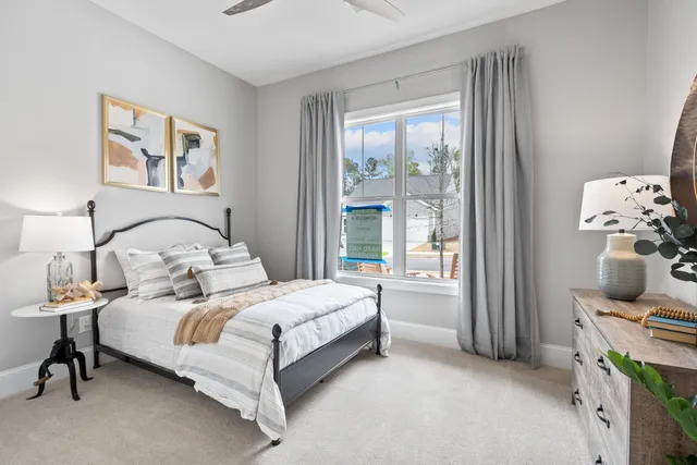 a bedroom with a bed and large window