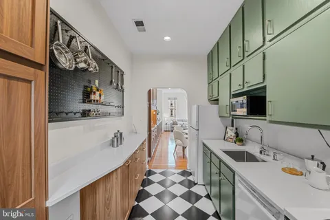 a kitchen with stainless steel appliances a sink stove and cabinets
