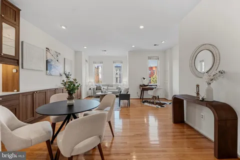 a living room with furniture rug and wooden floor