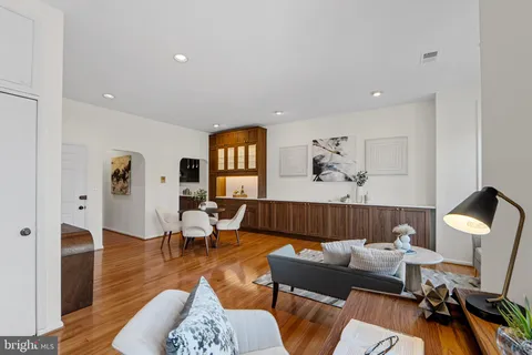 a living room with furniture and a wooden floor