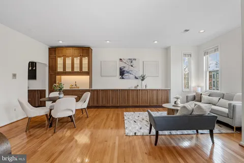 a living room with furniture a wooden floor and a rug