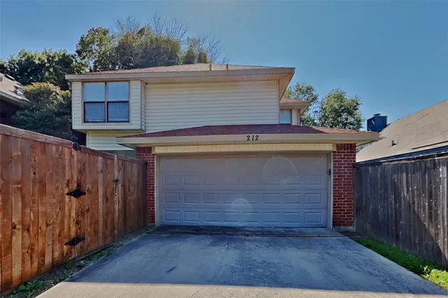 a view of house with wooden fence