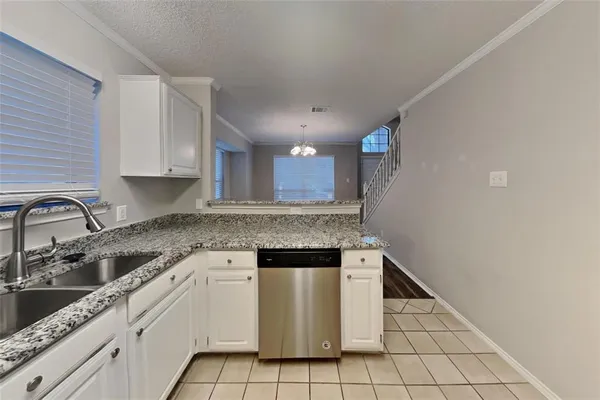 a kitchen with a sink cabinets and stainless steel appliances