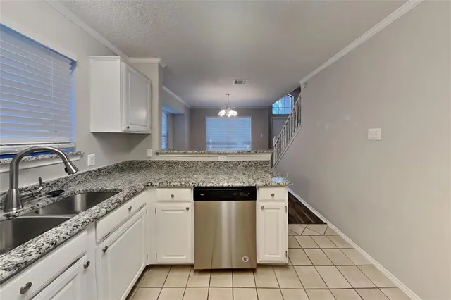 a kitchen with a sink cabinets and stainless steel appliances