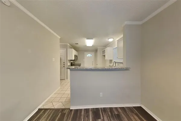 a view of kitchen and wooden floor