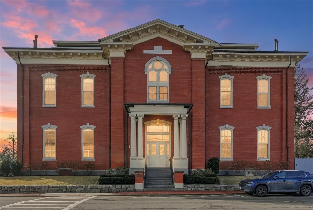 a view of a building with car parked