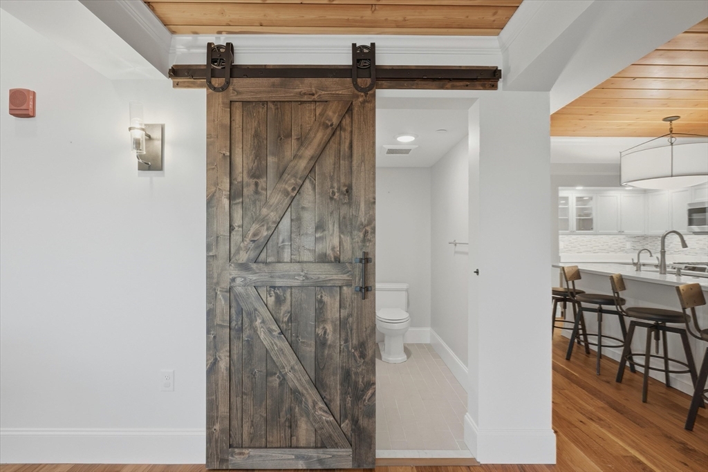 151 High Street, Unit 3B Newburyport, MA 01950 - Photo 15 of 39 a bathroom with a granite countertop shower a mirror and a sink