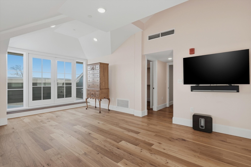 151 High Street, Unit 3B Newburyport, MA 01950 - Photo 19 of 39 a view of a livingroom with wooden floor and a flat screen tv