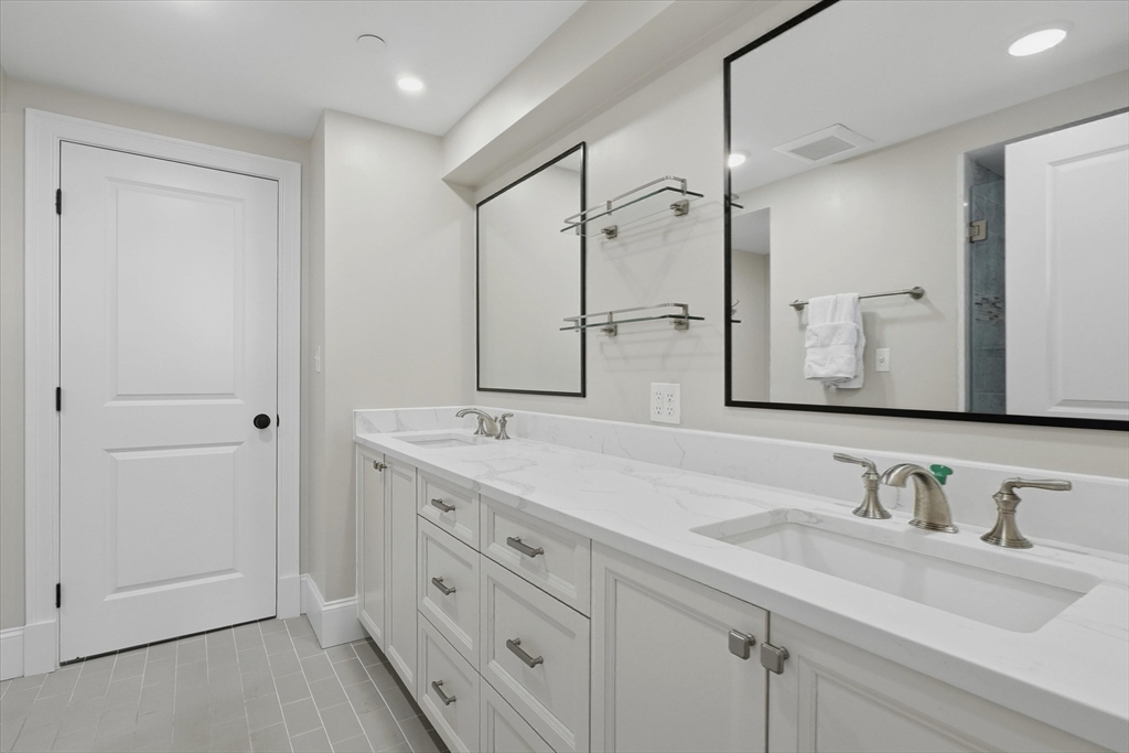 151 High Street, Unit 3B Newburyport, MA 01950 - Photo 21 of 39 a bathroom with double vanity sink and a mirror