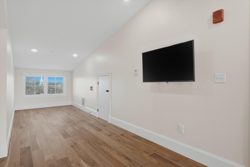 151 High Street, Unit 3B Newburyport, MA 01950 - Photo 26 of 39 a view of a livingroom with wooden floor