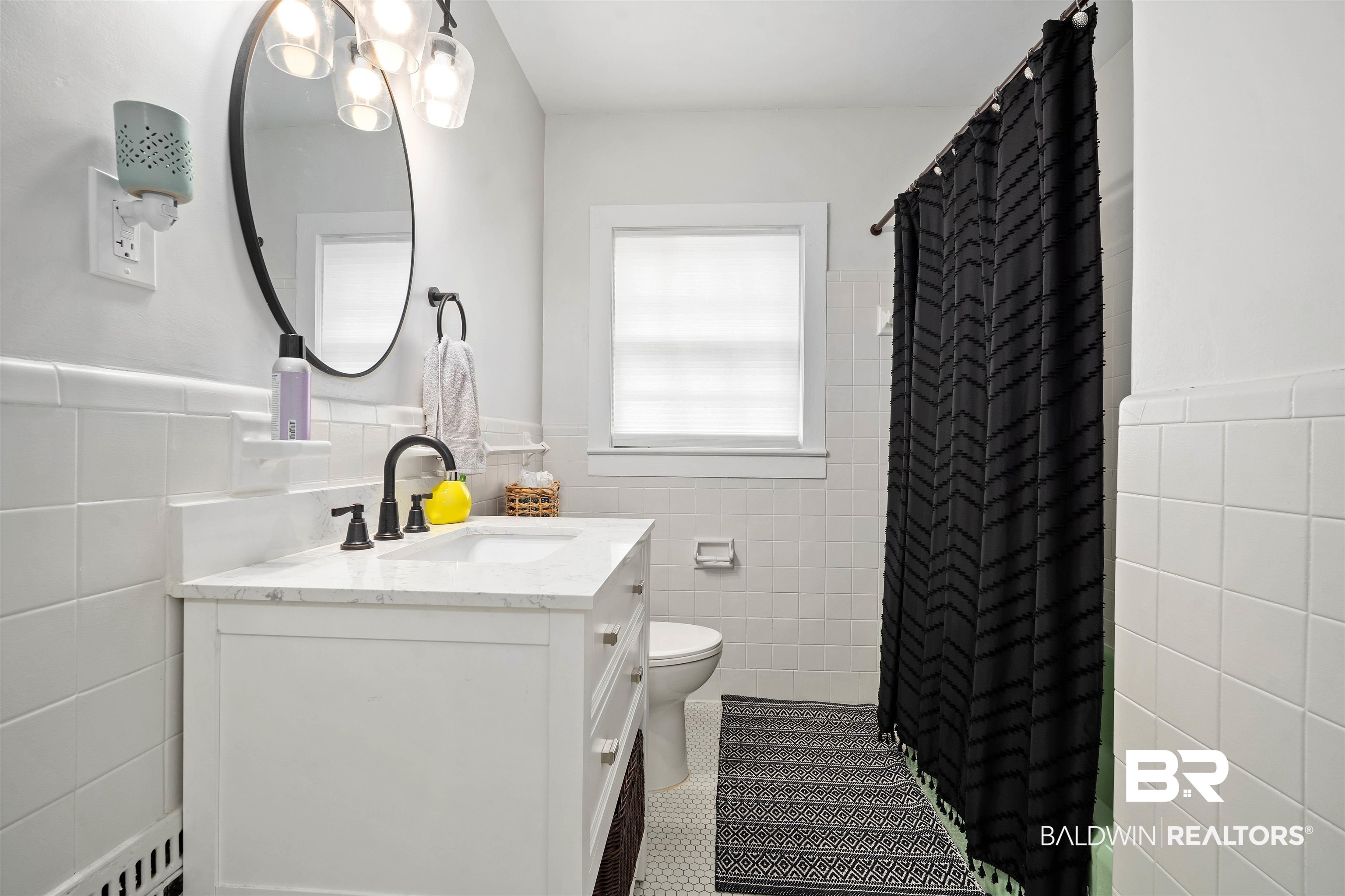 103 Emogene Place Mobile, AL 36606 - Photo 21 of 32 Bathroom with tile walls, vanity, wainscoting, dark tile patterned flooring, and a shower with shower curtain