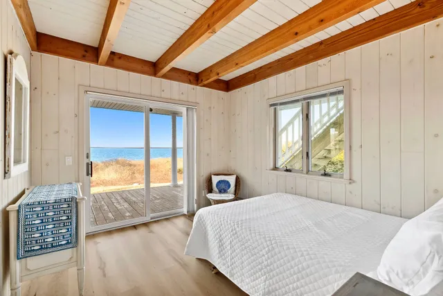 a bedroom with a large bed and a large window