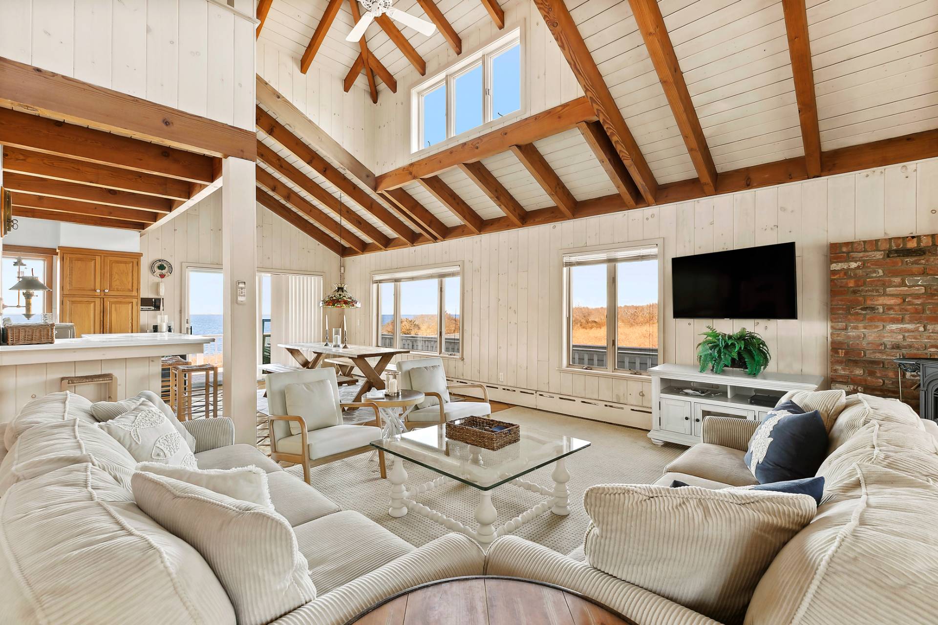 58 Firestone Road Montauk, NY 11954 - Photo 7 of 26 a living room with furniture a flat screen tv and a large window