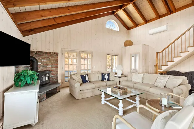 a living room with fireplace furniture and a flat screen tv