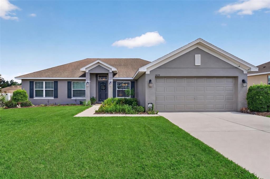 2429 Twin Lake View Road Winter Haven, FL 33881 - Photo 1 of 37 a front view of a house with a yard and garage