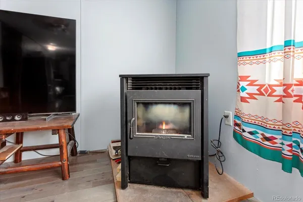 a living room with a fireplace and a flat screen tv