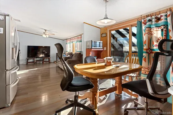 a view of a dining room with furniture window and wooden floor
