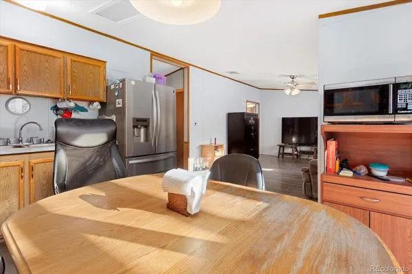 a bedroom with a bed a dresser and flat screen tv