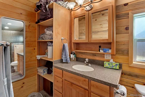 a bathroom with a sink a vanity and a mirror