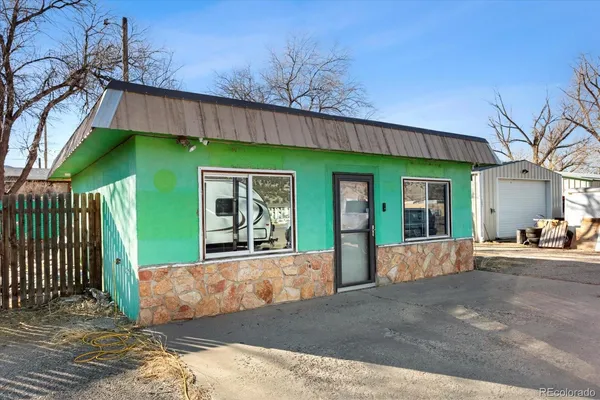 a view of a house with a patio and a yard