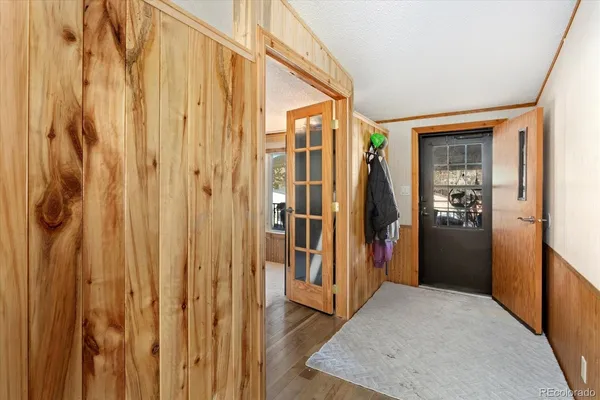 a view of a hallway with wooden walls and stairs