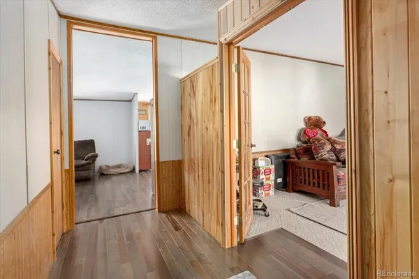 a hallway with closet and wooden floor