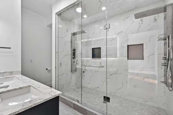 a bathroom with a shower and a sink