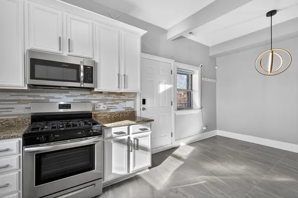 a kitchen with appliances cabinets and a counter top space