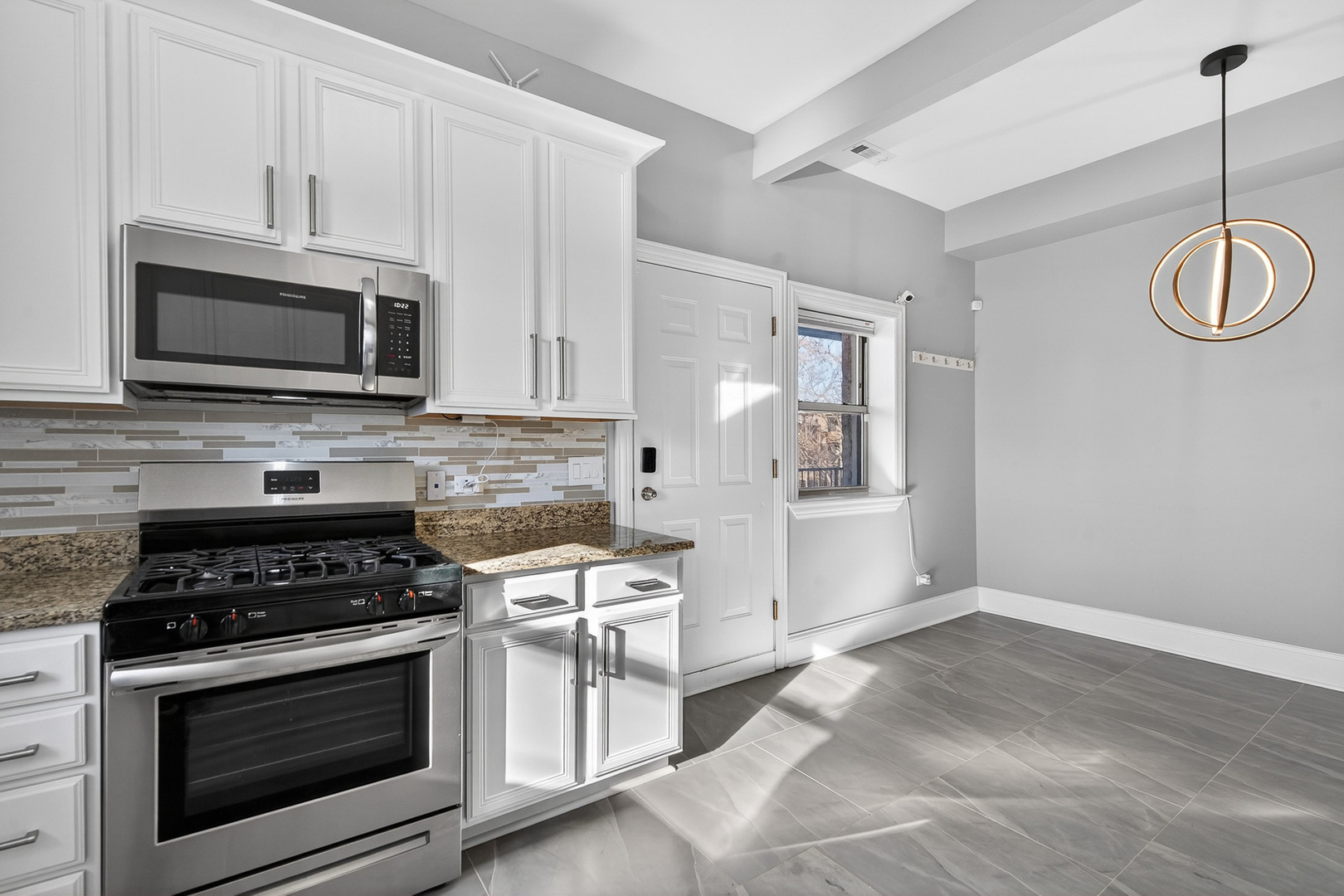 4646 South Prairie Avenue, Unit 2S Chicago, IL 60653 - Photo 20 of 32 a kitchen with stainless steel appliances a stove a microwave and cabinets