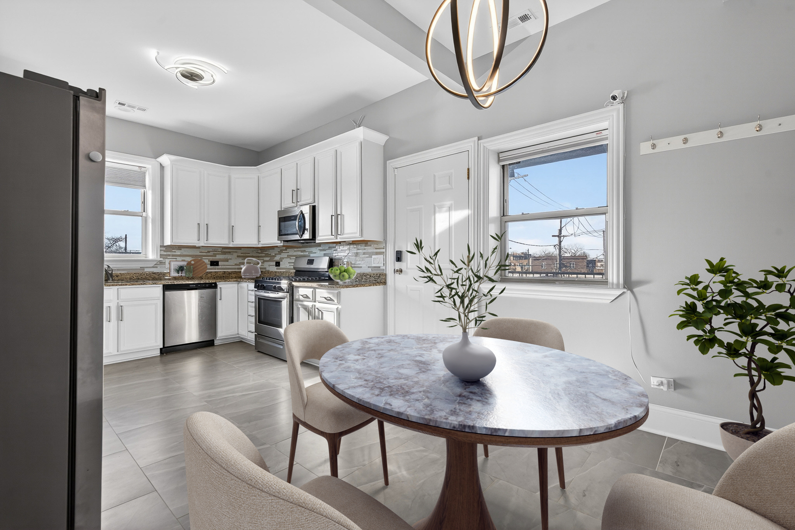 4646 South Prairie Avenue, Unit 2S Chicago, IL 60653 - Photo 22 of 32 a kitchen with stainless steel appliances a dining table and chairs