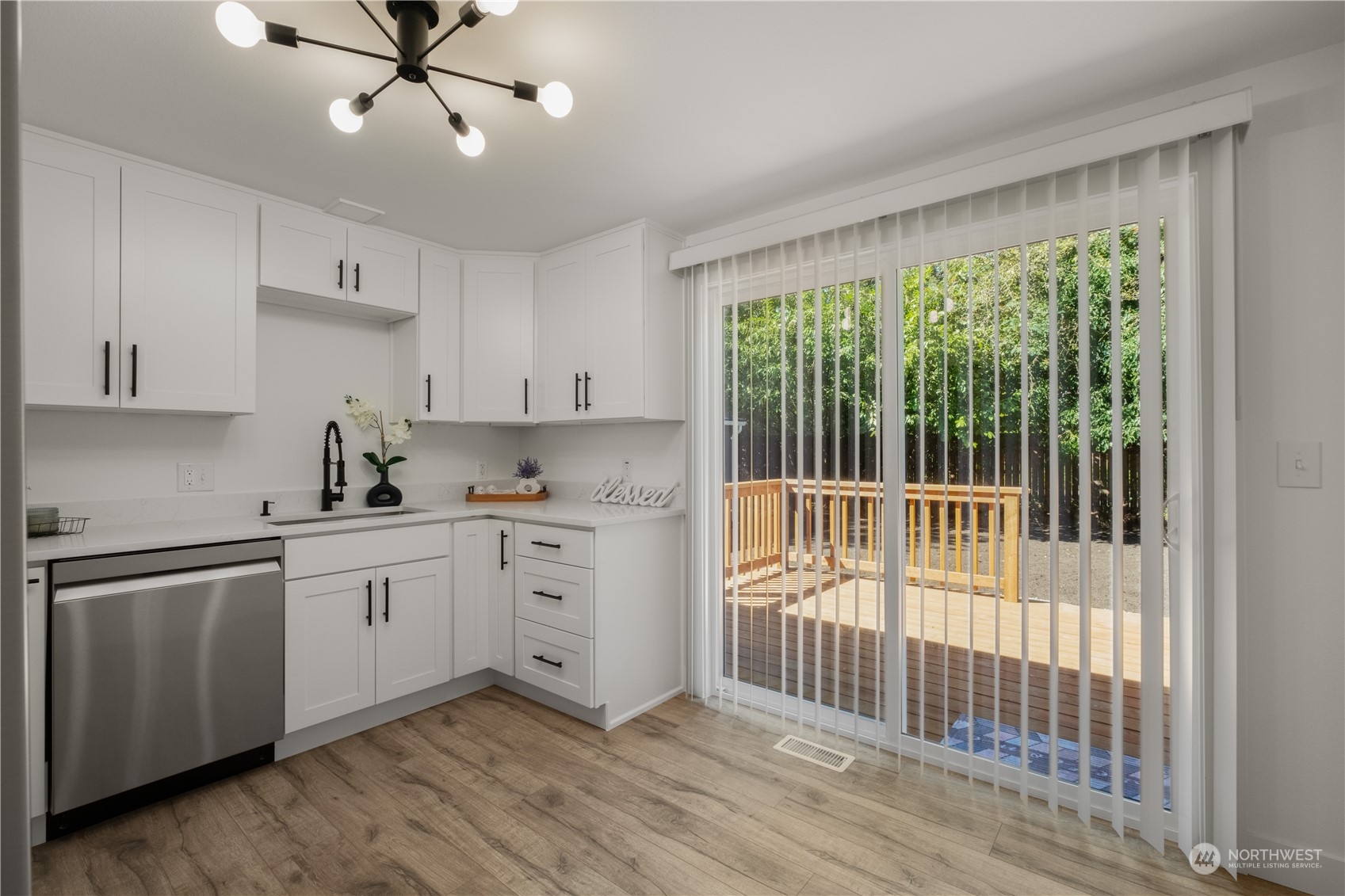 11610 Tower Road Southwest Lakewood, WA 98498 - Photo 11 of 35 a kitchen with a large window appliances and cabinets