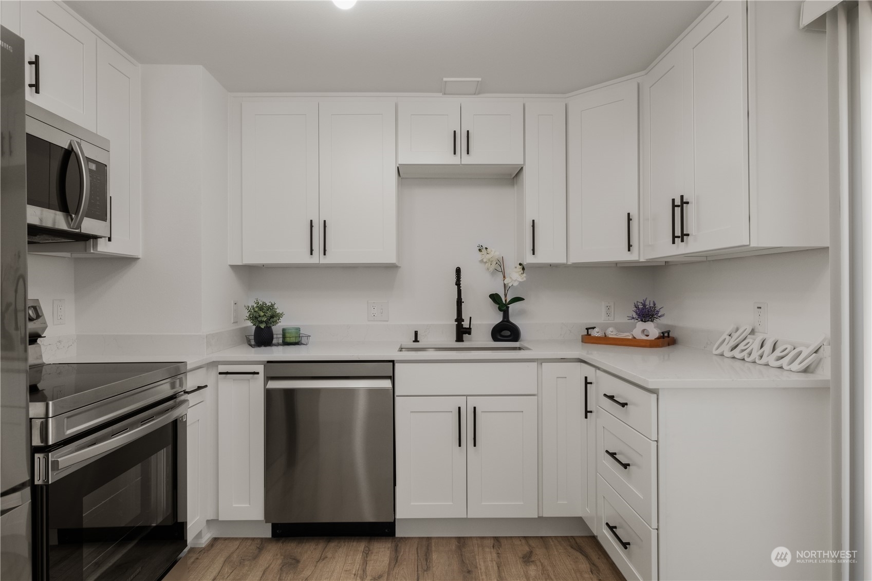 11610 Tower Road Southwest Lakewood, WA 98498 - Photo 13 of 35 a kitchen with stainless steel appliances granite countertop a sink and a stove