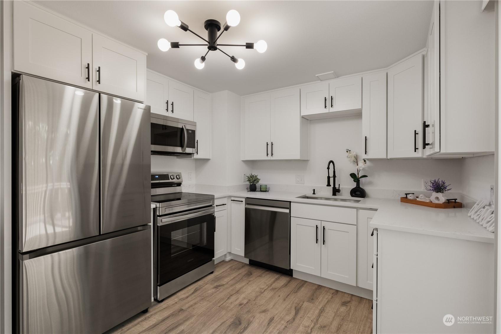 11610 Tower Road Southwest Lakewood, WA 98498 - Photo 14 of 35 a kitchen with stainless steel appliances a refrigerator sink and cabinets