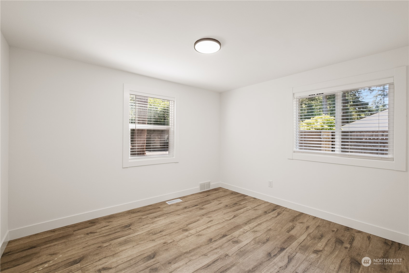 11610 Tower Road Southwest Lakewood, WA 98498 - Photo 18 of 35 wooden floor in an empty room with a window