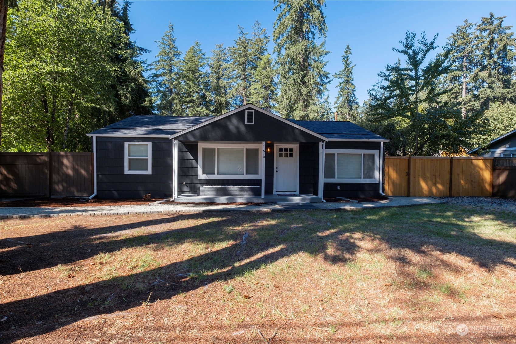 11610 Tower Road Southwest Lakewood, WA 98498 - Photo 2 of 35 a front view of a house with a yard garage and outdoor seating