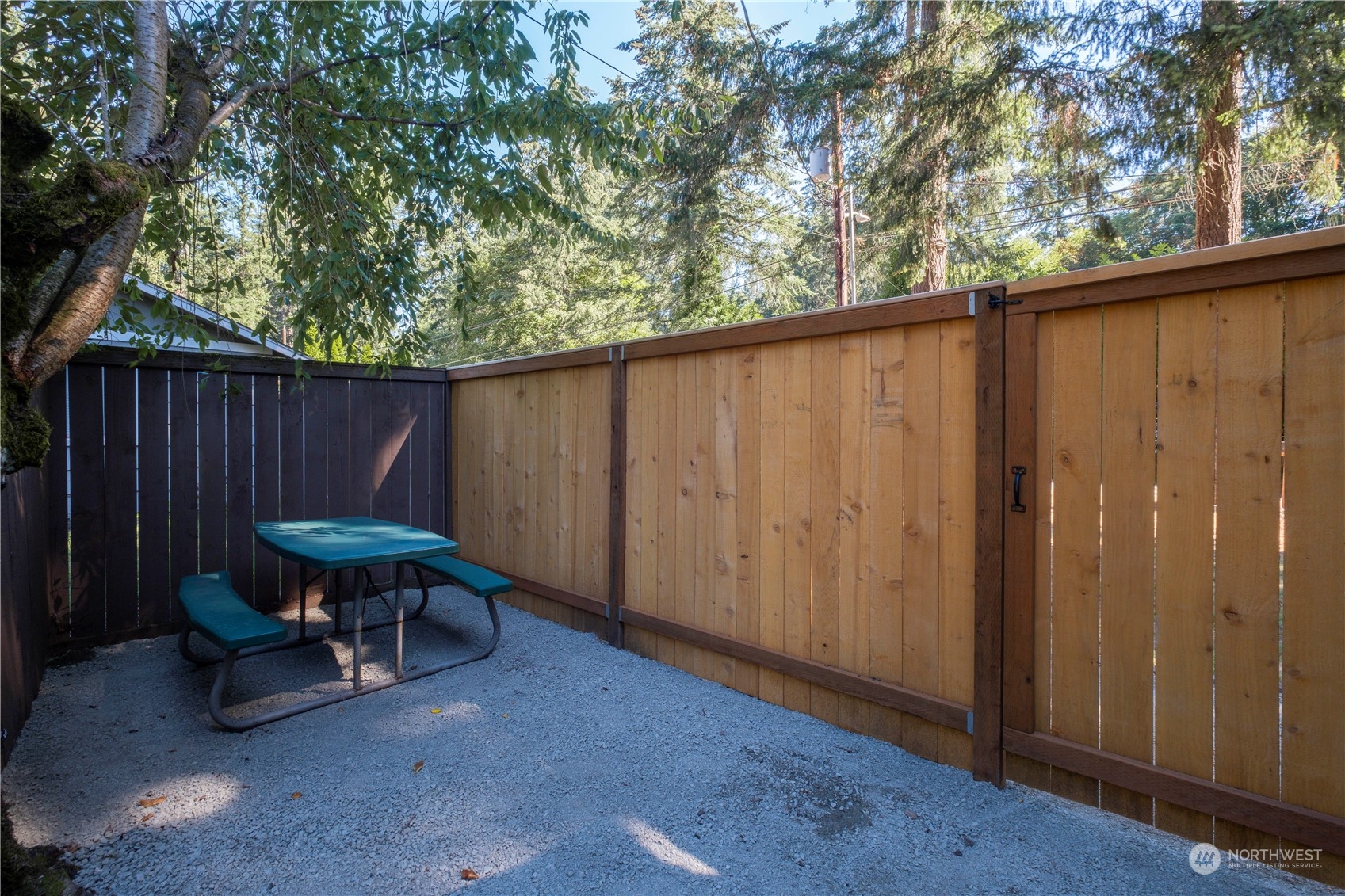 11610 Tower Road Southwest Lakewood, WA 98498 - Photo 22 of 35 a backyard of a house with barbeque oven table and chairs