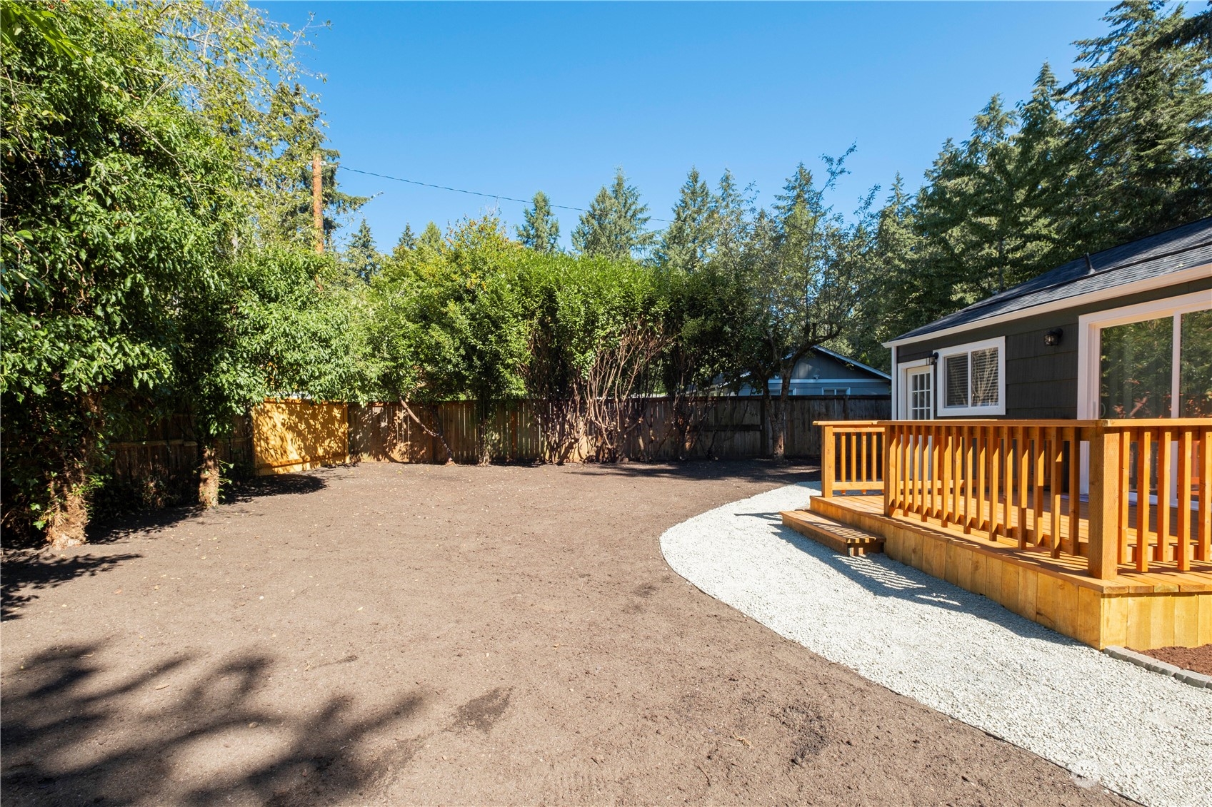 11610 Tower Road Southwest Lakewood, WA 98498 - Photo 27 of 35 a view of backyard with deck and a garden