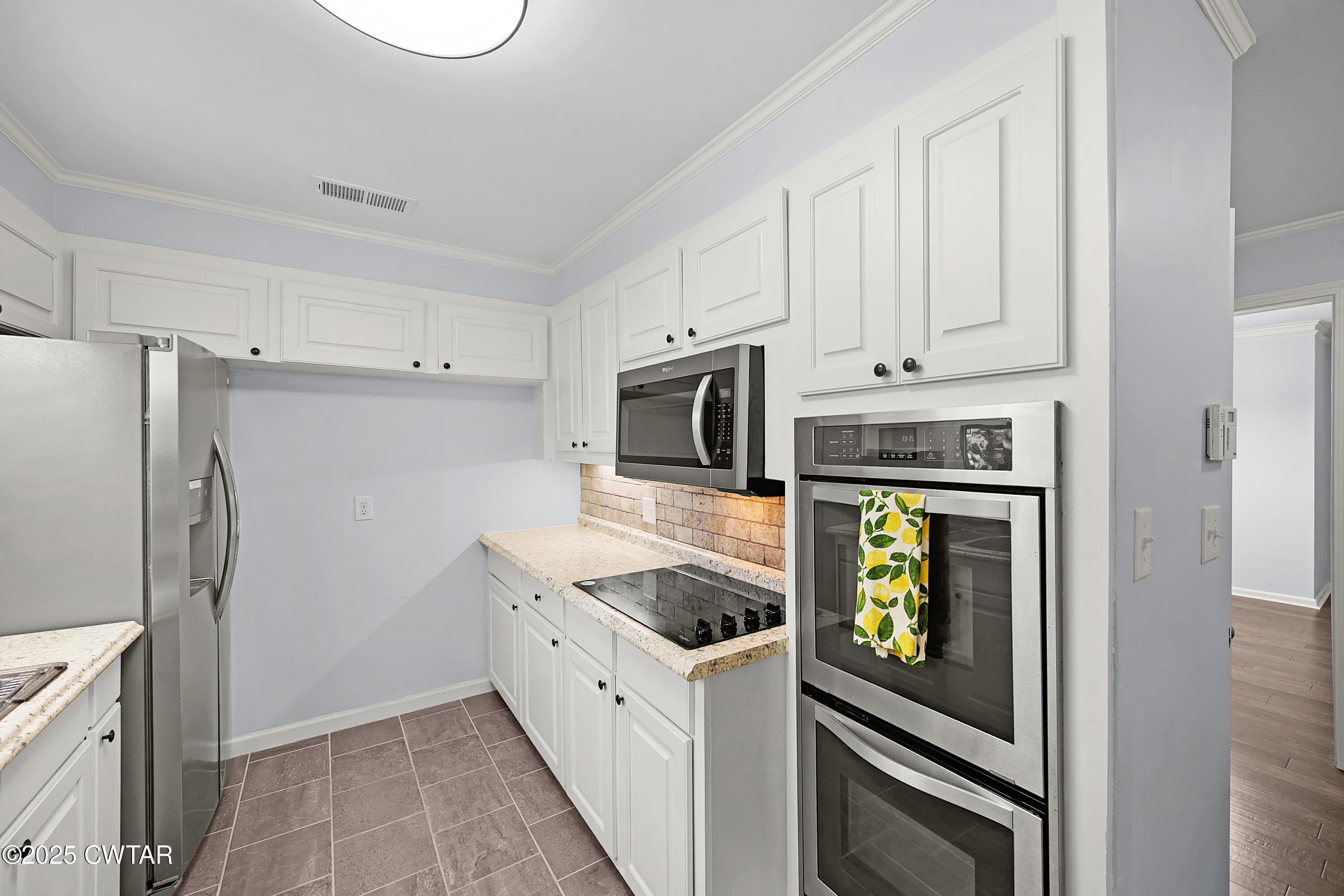 105 Dixie Lane Jackson, TN 38301 - Photo 11 of 25 a kitchen with stainless steel appliances granite countertop a refrigerator and a stove top oven