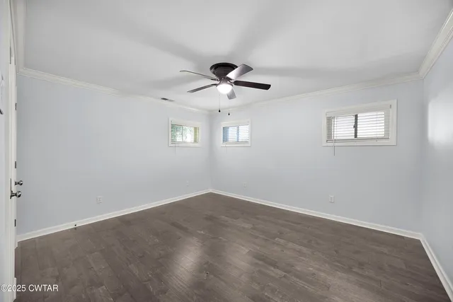 a view of a hallway with a chandelier fan