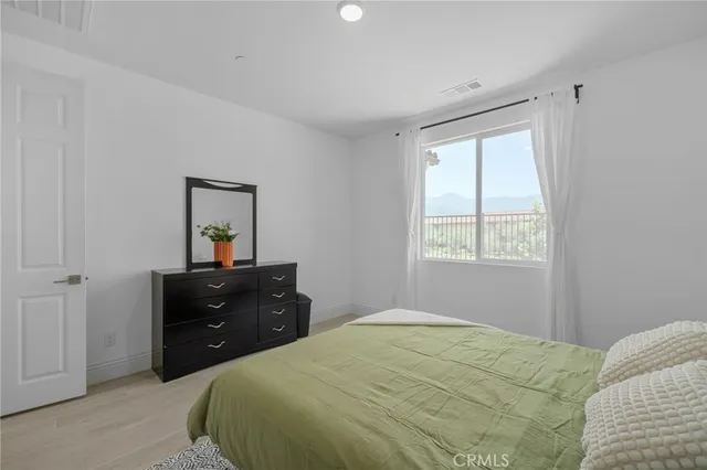 a bedroom with a bed and a mirror