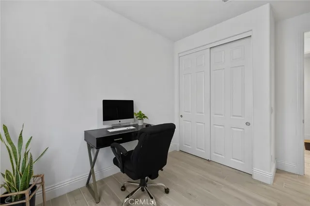 a view of a workspace with furniture and wooden floor