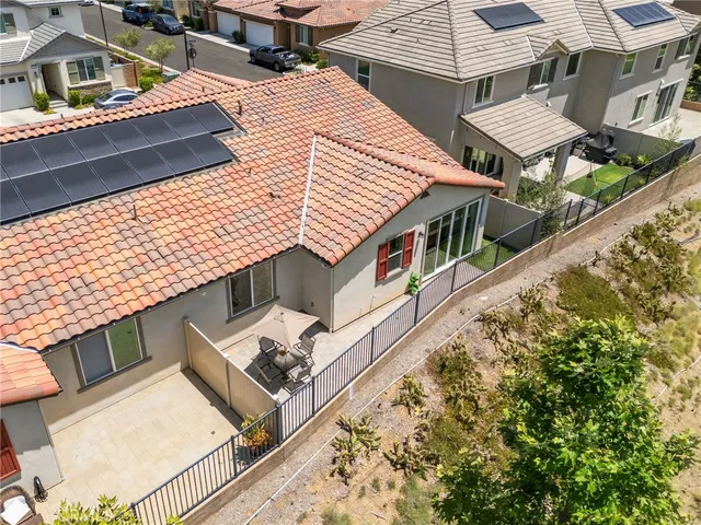 an aerial view of a house with a large trees