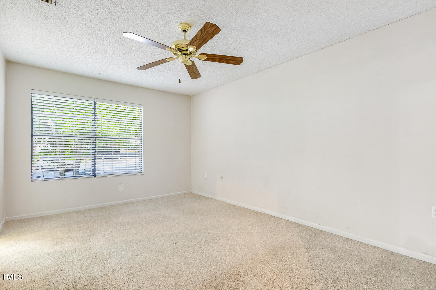 7747 Falcon Rest Circle Raleigh, NC 27615 - Photo 23 of 36 an empty room with a window and a fan