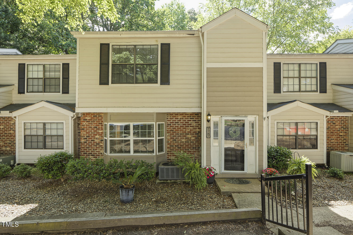 7747 Falcon Rest Circle Raleigh, NC 27615 - Photo 3 of 36 a front view of a house with garden