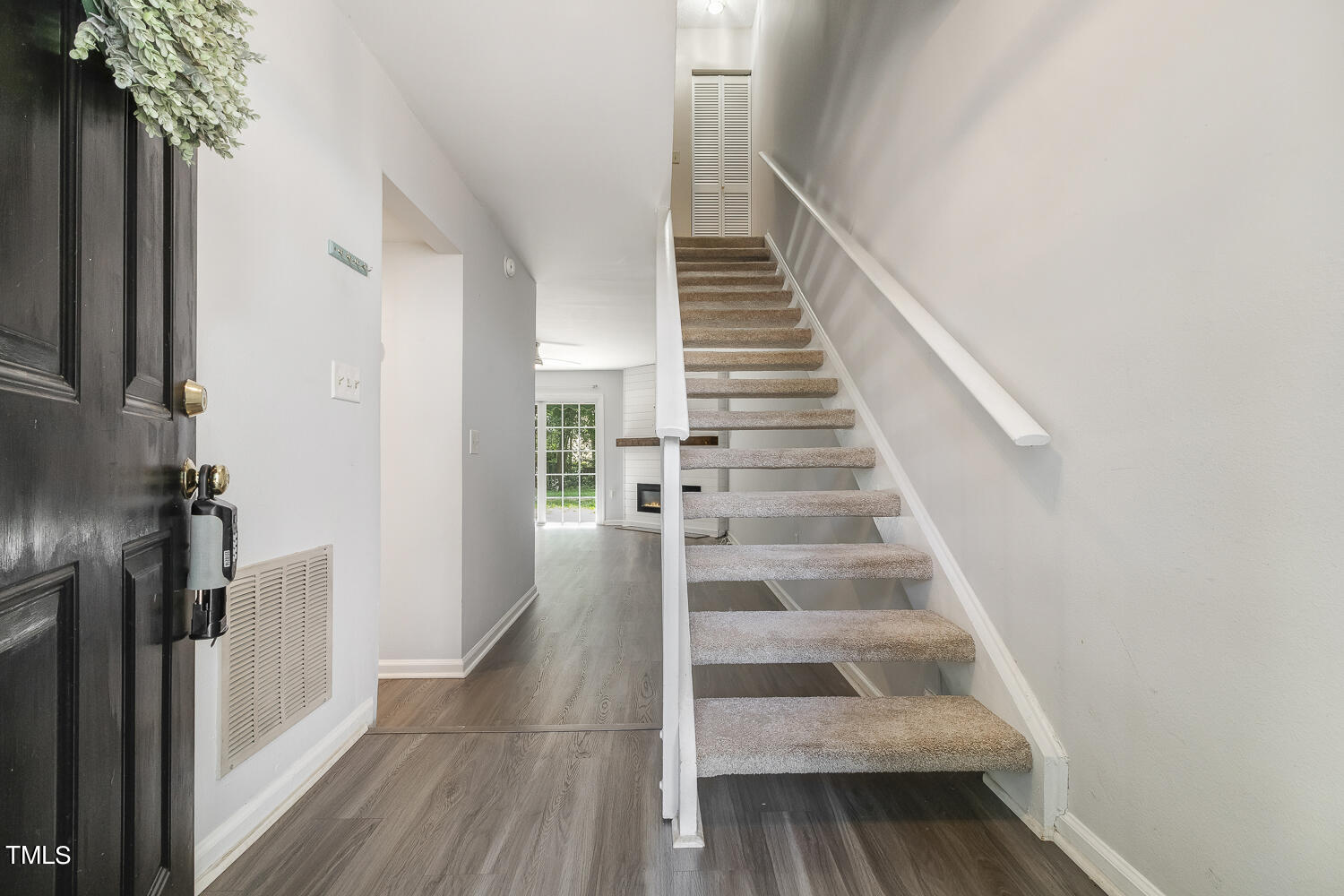 7747 Falcon Rest Circle Raleigh, NC 27615 - Photo 5 of 36 a view of entryway and hall with wooden floor