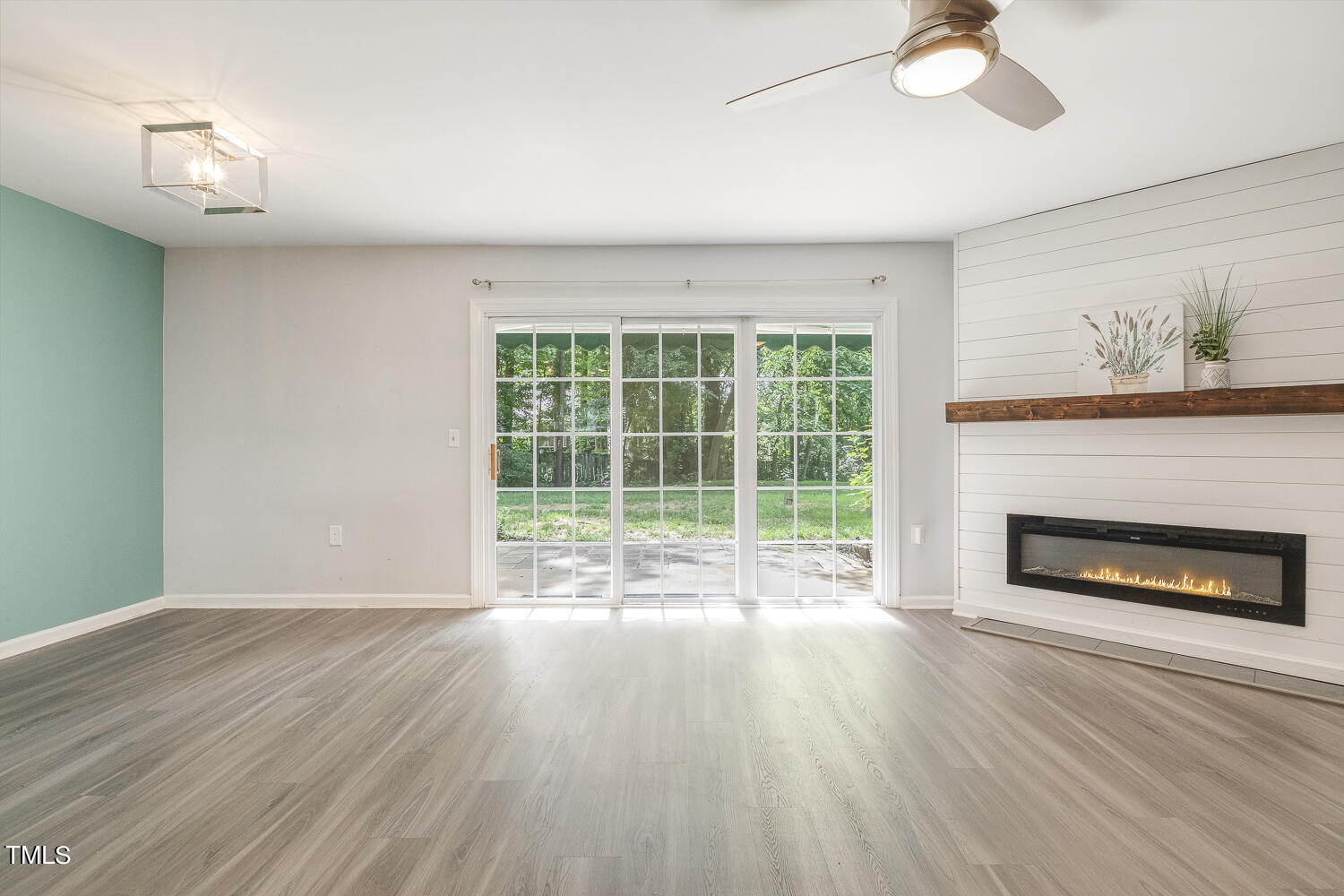 7747 Falcon Rest Circle Raleigh, NC 27615 - Photo 7 of 36 a view of wooden floor fire place and windows in a room