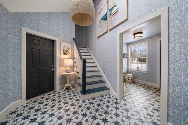 a view of a hallway with entryway wooden floor and front door