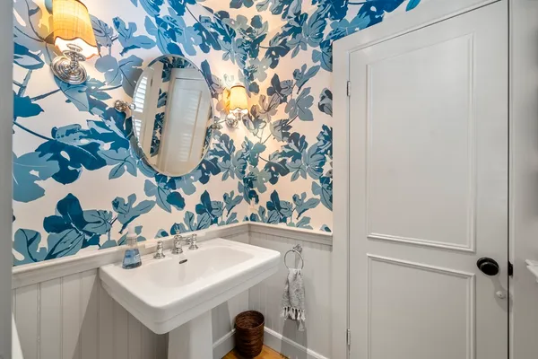 a bathroom with a sink and mirror with vanity
