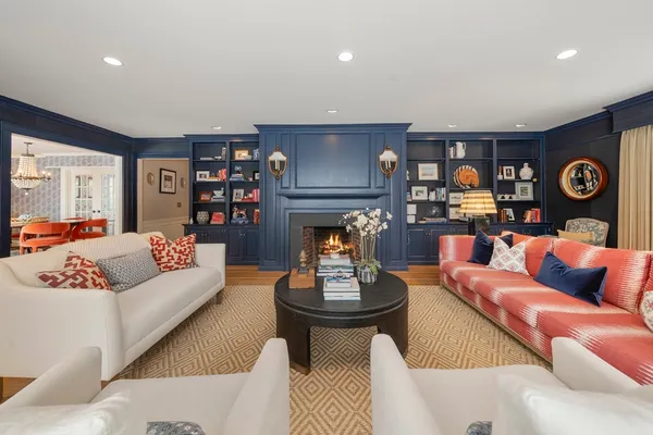 a living room with furniture kitchen view and a fireplace